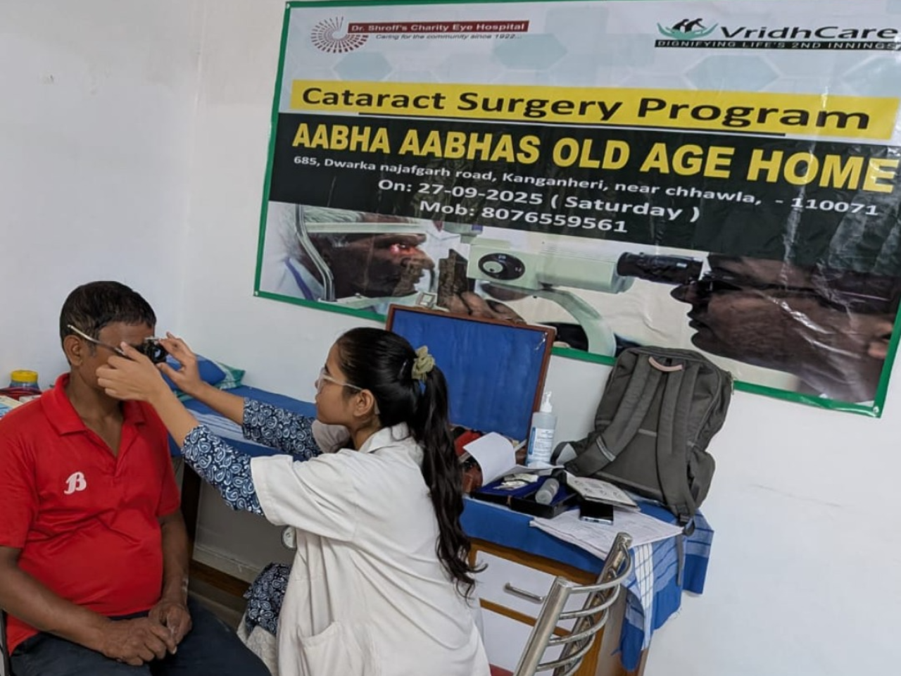 eye patient getting checked up by eye camp volunteer doctor