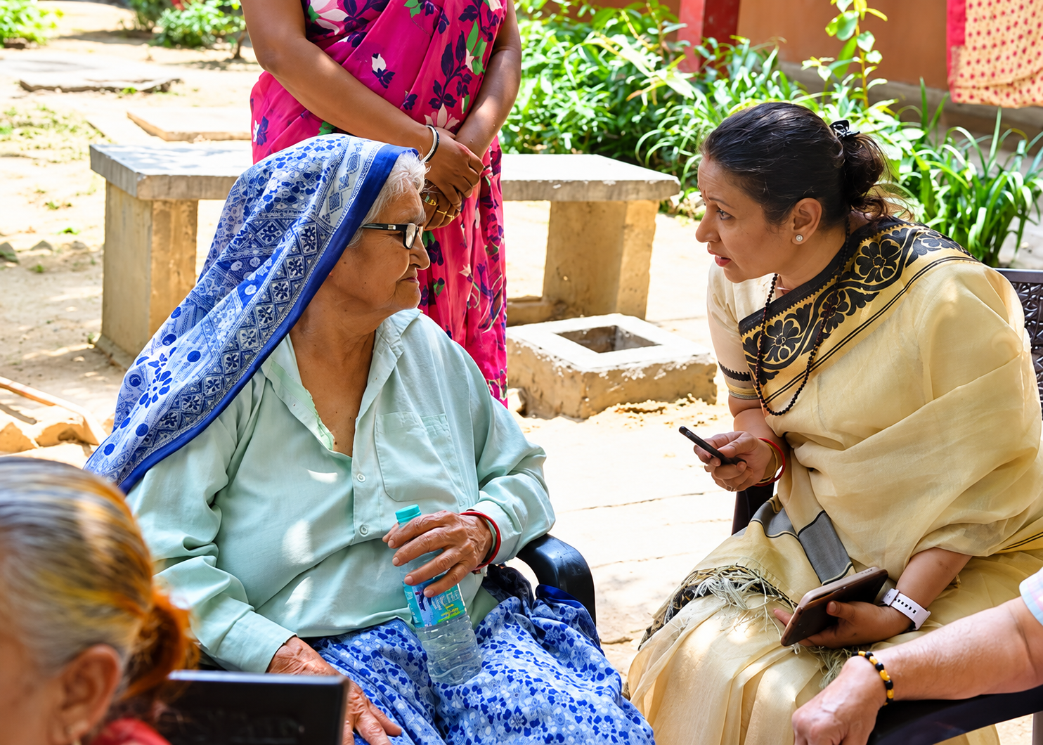 old age home donation collecting volunteer talking to old age women