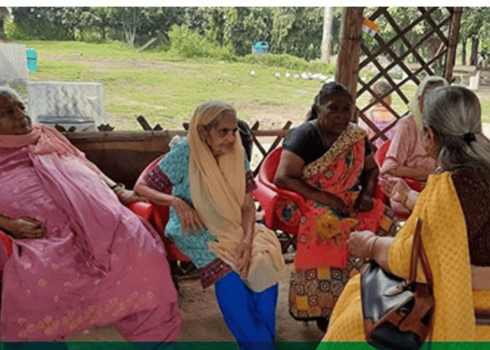 eye camp senior volunteer talking to senior citizens