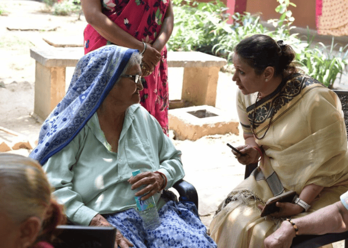 old age home donation collecting volunteer talking to old age women